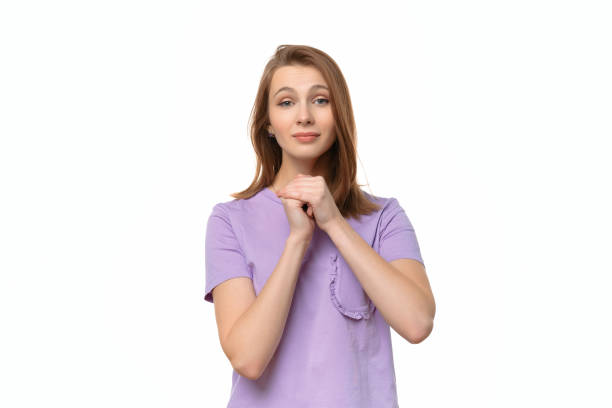 istock Attractive girl looks with imploring expression asks to give one more chance, keeps palms pressed together 1307704060