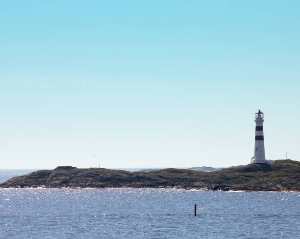istock A sea landscape with a little island with a lighthouse on it 1307704812