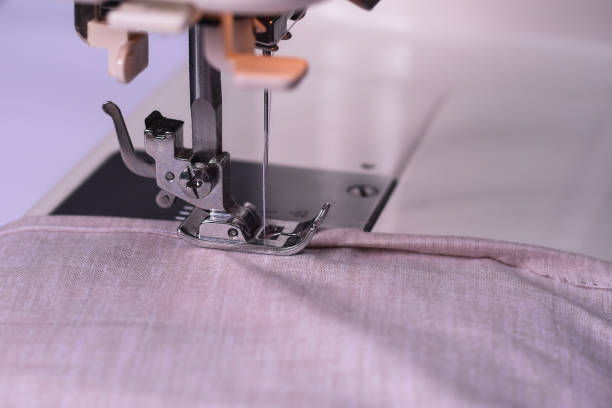 istock The light fabric lies on the sewing machine 1307706333