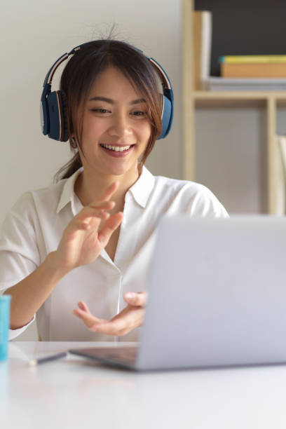 istock A woman with headphone talking with her colleagues while video conference 1307706721