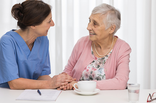 Care - senior woman with home caregiver