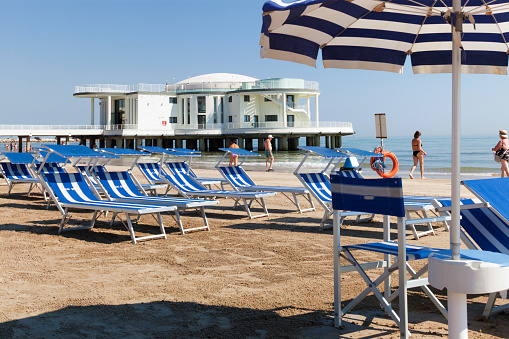 Umbrella and beach chair before La Rotonda a Mare' resort