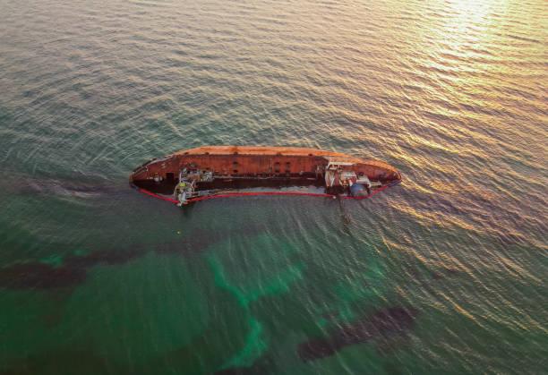 istock The old rusty ship was stranded by a storm. Oil spill from a tanker, environmental pollution. Ship at sunris 1307709378