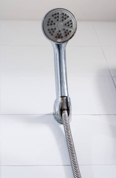 istock Old chrome shower is hanging near the tile wall. 1307711029