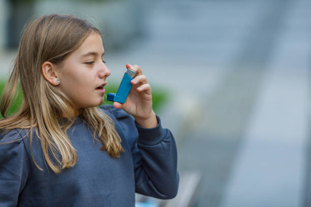 istock Girl With Breathing Problems is Using an Asthma Inhaler. 1307711125