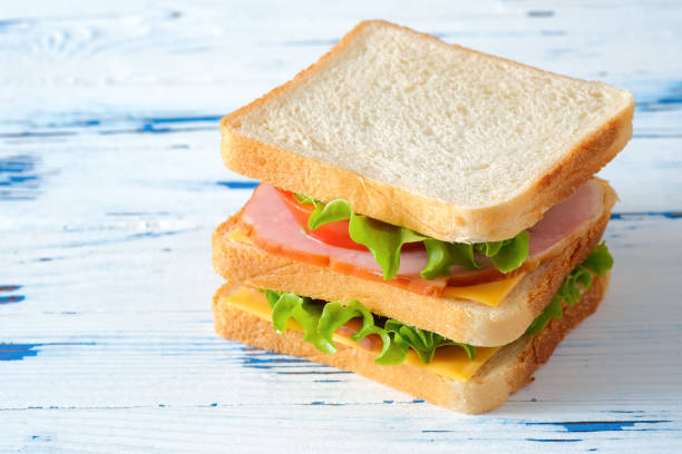 istock Big tasty sandwich on rustic wooden background 1307712068