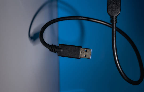 istock USB wire on blue and gray backgrounds. Close-up 1307714202