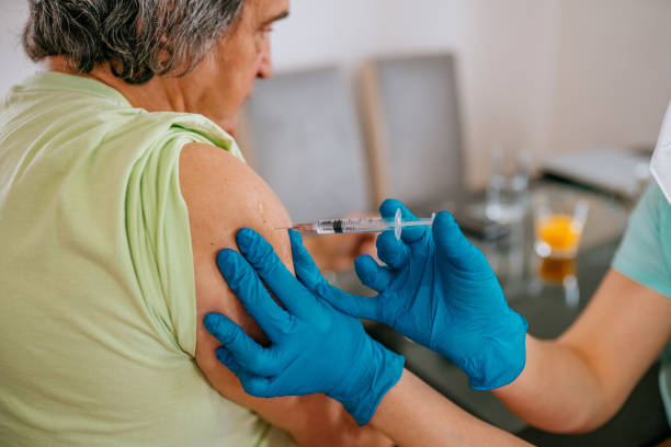 istock Patient getting vaccination at home - mature man 1307715426