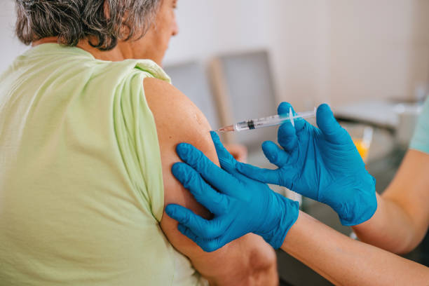 istock Patient getting vaccination at home - mature man 1307715438