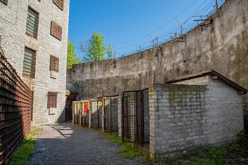 Tallinn, Estonia - May 22 2020: Yard of  abandoned patarei prison (Estonian - Patarei Vangla). Empty prison dog houses. Selective focus.