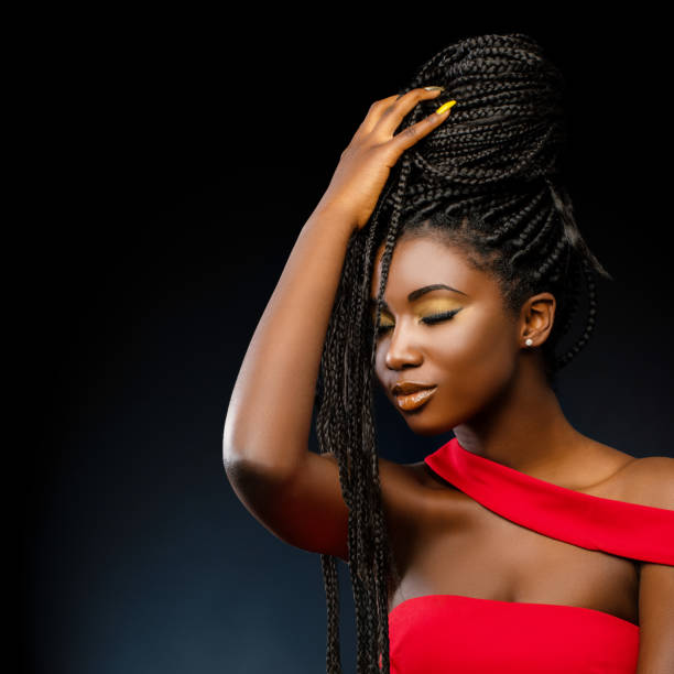 istock African woman holding braids with eyes closed. 1307716925