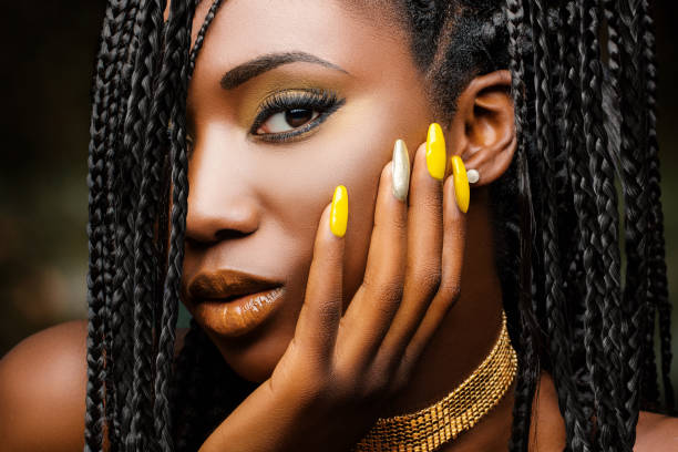 Beauty portrait of sensual african woman. Extreme close up beauty portrait of charming african woman with hand on cheek. Girl with braided hairstyle and sensual look against dark background. natural black hair photos stock pictures, royalty-free photos & images
