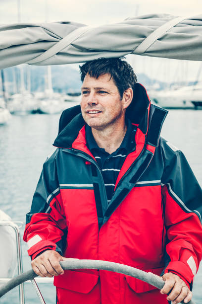 istock Happy skipper on sailboat 1307717767