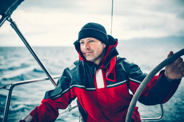 istock Happy skipper on sailboat 1307717804