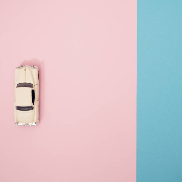 istock White limousine on a pink and blue pastel background. Minimal pattern. 1307717954