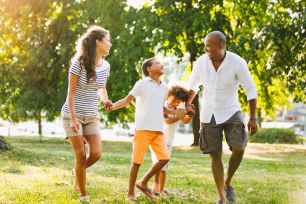 istock Happy couple spending time with their sons in the park 1307718510