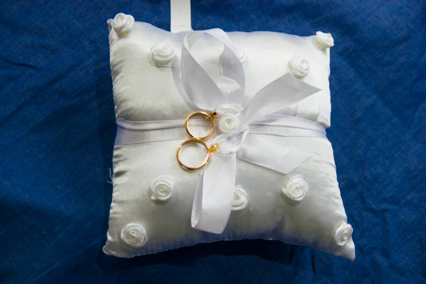 istock love forever, wedding rings on pillow with beautiful and fragrant flowers 1307719399