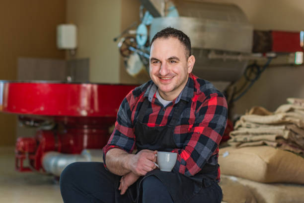 istock Coffee roasting shop owner holding coffee cup 1307719774