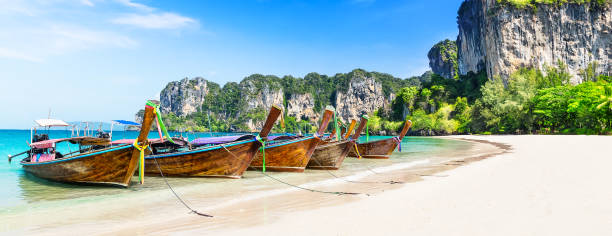 Thai traditional wooden longtail boat and beautiful sand beach. Thai traditional wooden longtail boat and beautiful sand Railay Beach in Krabi province. Ao Nang, Thailand. koh poda stock pictures, royalty-free photos & images