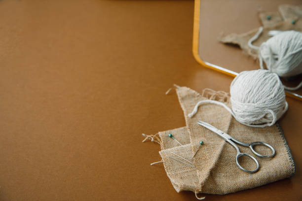 istock Sewing accessories and fabric on a blue background. Fabric, sewing threads, needle and sewing centimeter. top view, flatlay, copyspace 1307720943