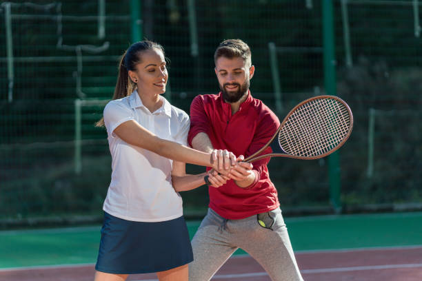istock Two young people training on the tennis court 1307721041