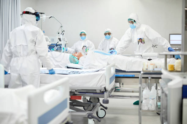 istock Medical workers bringing COVID patient in ICU 1307721131