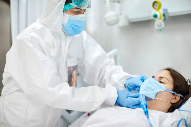 istock Doctor adjusting oxygen mask of patient in ward 1307721156
