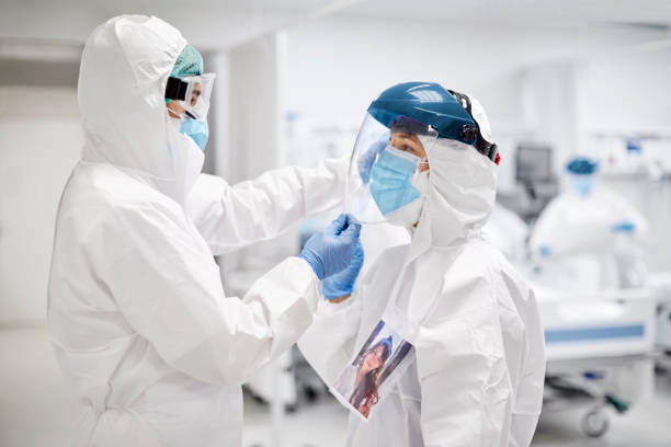 istock Doctors wearing white coveralls during COVID-19 1307721165