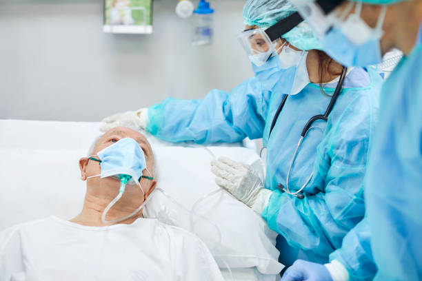 istock Man talking to doctors in hospital during COVID-19 1307721189