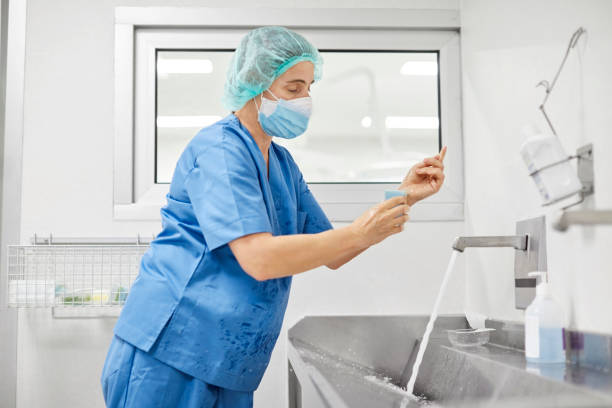 istock Nurse scrubbing hands at sink during COVID-19 1307721653