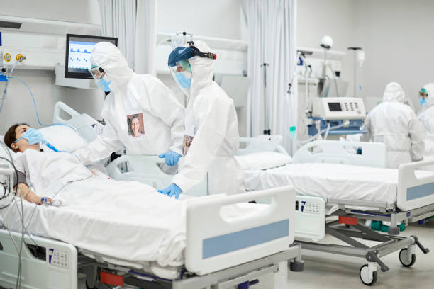 istock Doctor talking to patient in ward during COVID-19 1307721701