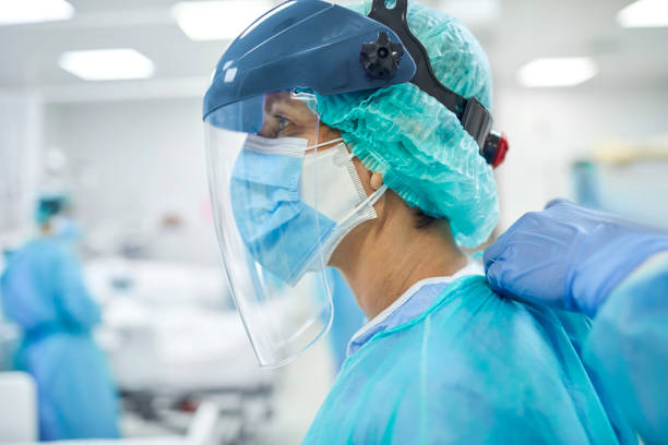 istock Doctors wearing protective suit during COVID-19 1307721704