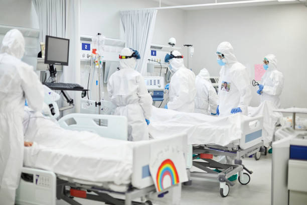 istock Doctors with COVID patient in hospital ward 1307721752
