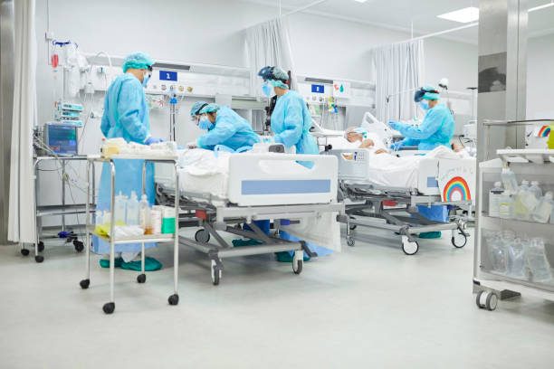 istock Doctors examining coronavirus patient in hospital 1307721758