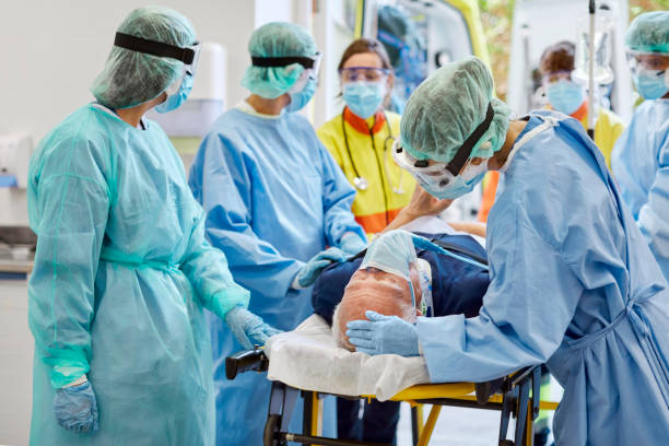 istock Healthcare workers bringing patient on stretcher 1307721833