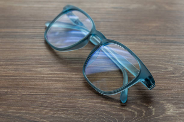 istock Eyeglassed blue color on wooden table office 1307722074