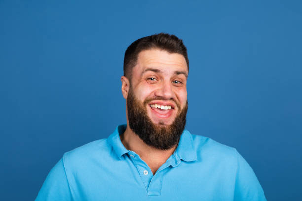 istock Caucasian man's portrait isolated on blue studio background with copyspace 1307723037