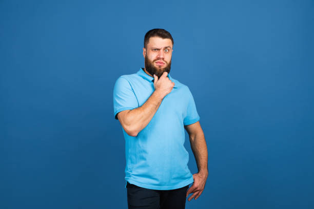 istock Caucasian man's portrait isolated on blue studio background with copyspace 1307723069