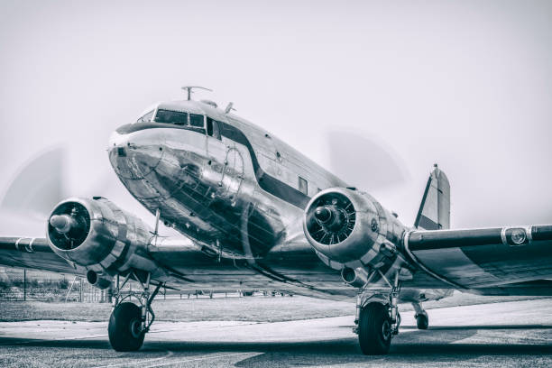 Vintage Douglas DC-3 propellor airplane ready for take off Vintage Douglas DC-3 propellor airplane ready for take off at the runway of an empty airfield. Image with a retro look. propeller photos stock pictures, royalty-free photos & images