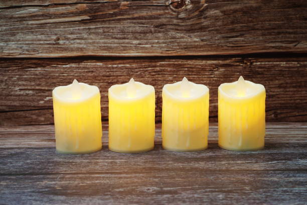 istock LED Candle Light electronic with space copy on wooden background 1307725137