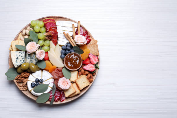 Assorted appetizer served on white wooden table, top view. Space for text Assorted appetizer served on white wooden table, top view. Space for text charcuterie stock pictures, royalty-free photos & images