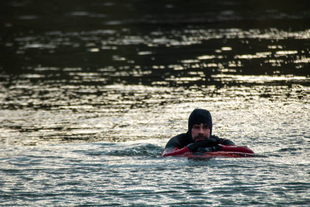 istock Cold water swimmer in wetsuit with inflatable 1307726580