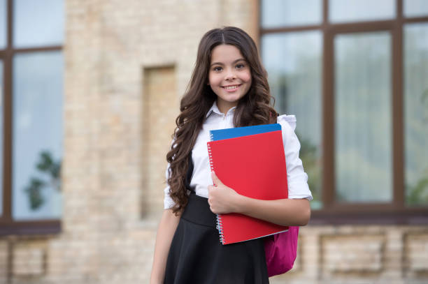 istock Shaping little minds. Happy child hold library book. Cute bookworm outdoors. School library. Reading and literacy education. Literature lesson. More knowledge never hurt anybody 1307726820