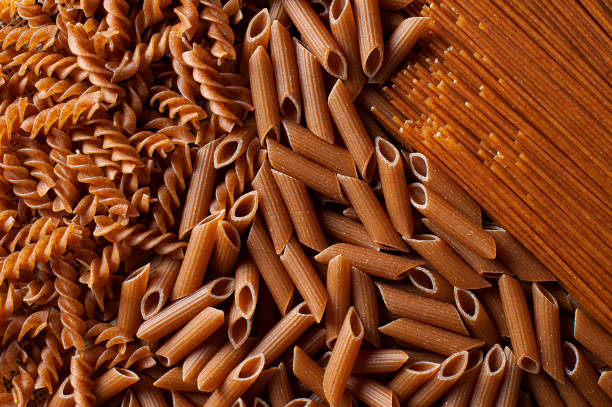 Raw wholemeal pasta, spaghetti, penne and fusilli. Top view