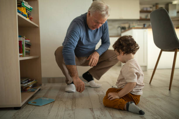 istock Grandfather and grandson having fun time playing at home 1307726959