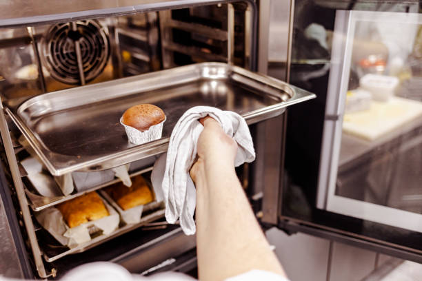 istock Chef opening the oven with bread and Pumpkin muffin 1307727055