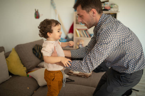 istock Young father playing with his cute son at home 1307728118