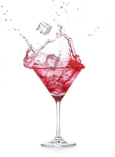 istock Cosmopolitan cocktail splashing on white background 1307728781