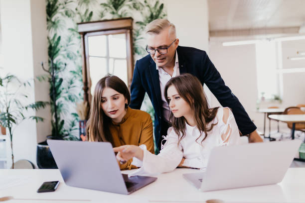 istock Colleagues team work at an office meeting working over laptop 1307729699