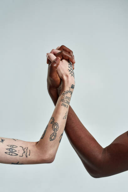 istock Multiracial couple putting their hands together in lock 1307730539